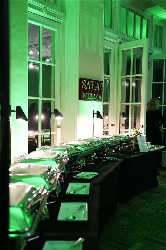 Black and white photo of a women performing modern dance on a dark background.