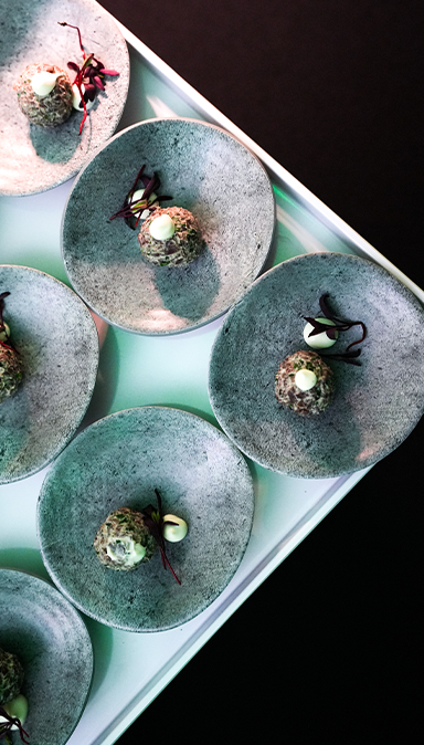 Black and white photo of a women performing modern dance on a dark background.