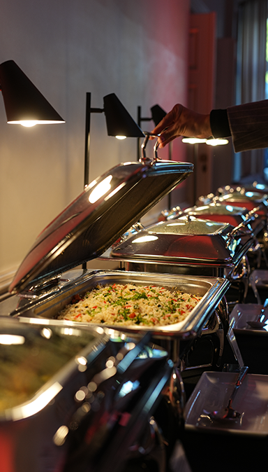 Black and white photo of a women performing modern dance on a dark background.