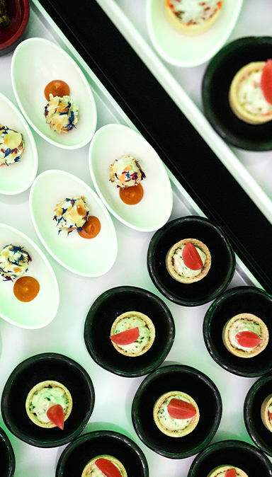 Black and white photo of a women performing modern dance on a dark background.