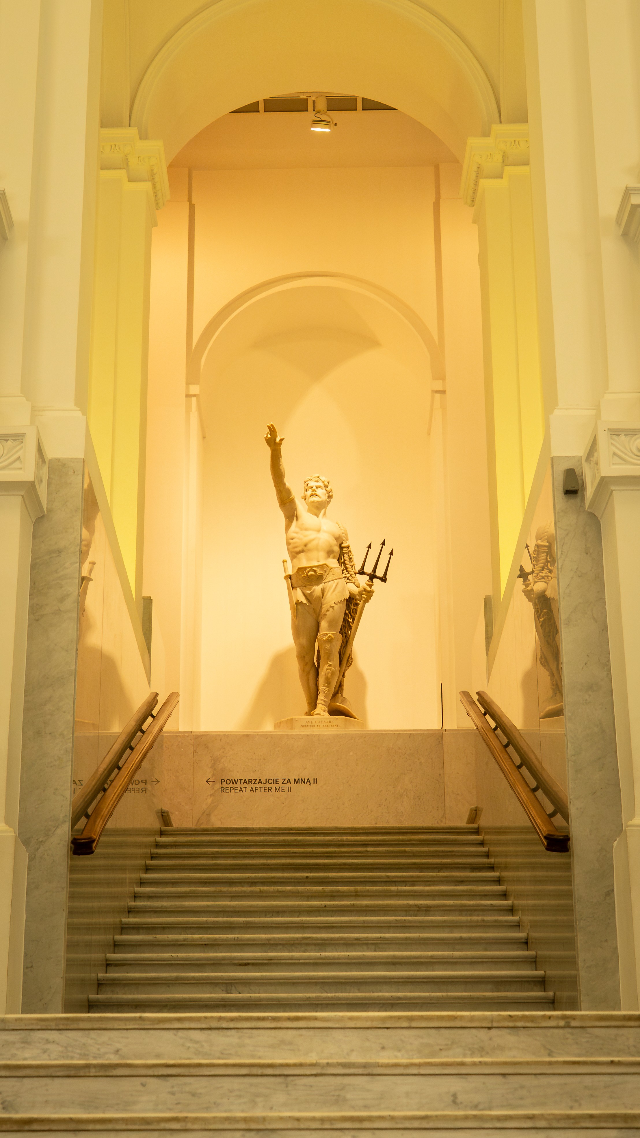 Black and white photo of a women performing modern dance on a dark background.