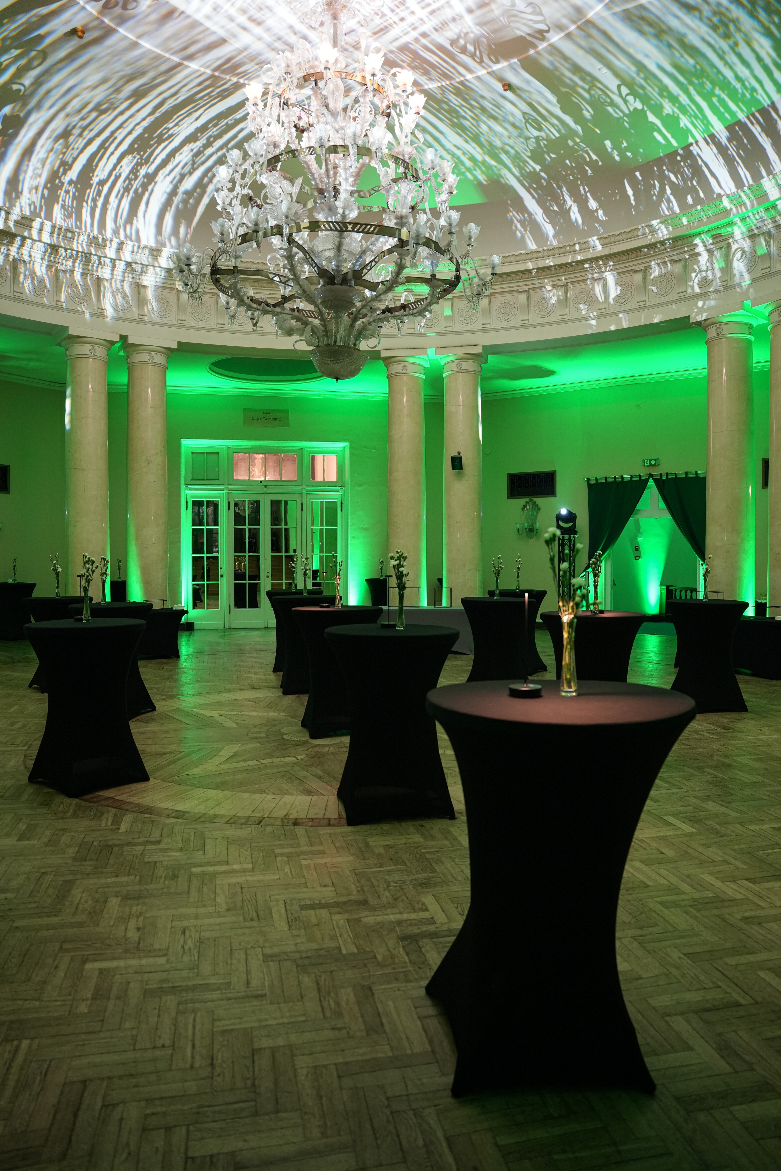 Black and white photo of a women performing modern dance on a dark background.
