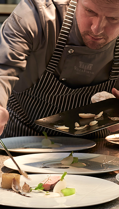 Black and white photo of a women performing modern dance on a dark background.