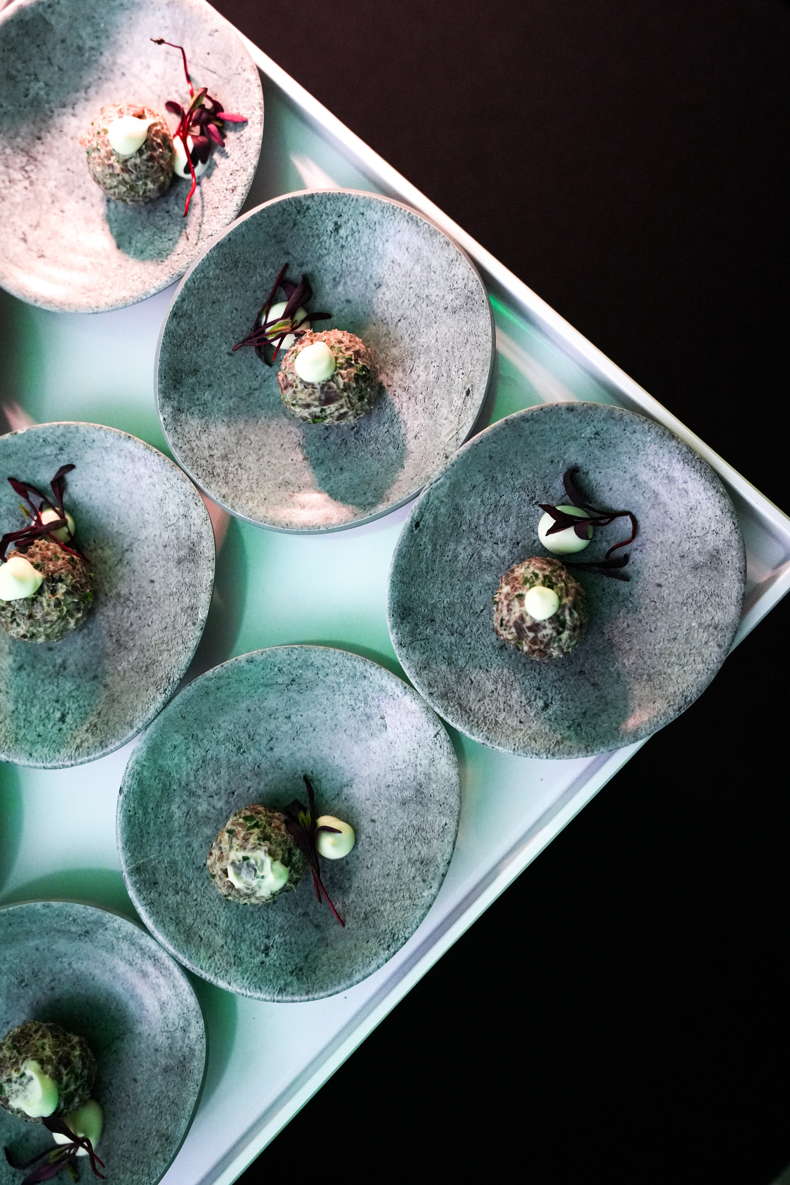 Black and white photo of a women performing modern dance on a dark background.