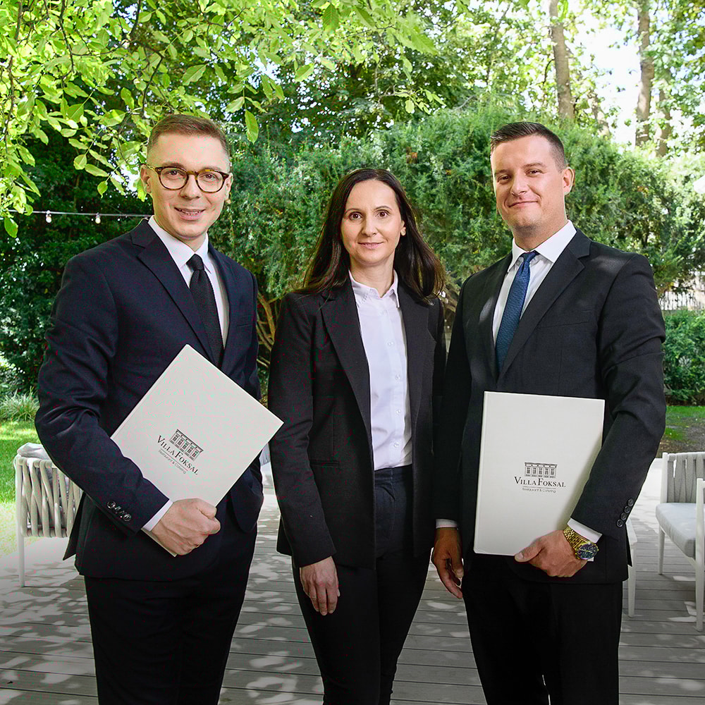 Black and white photo of a women performing modern dance on a dark background.