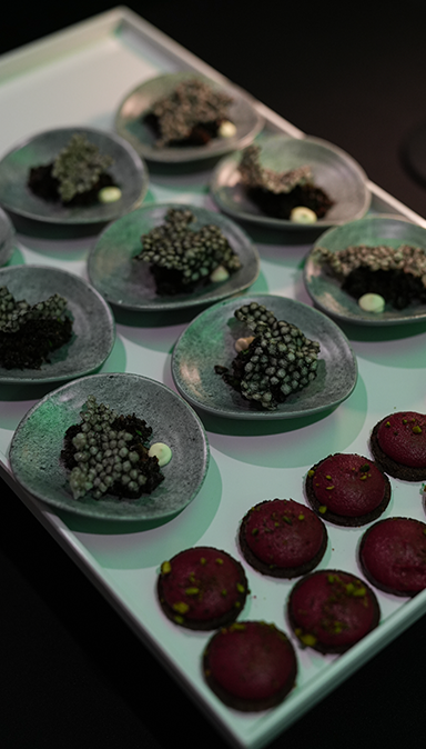 Black and white photo of a women performing modern dance on a dark background.